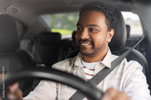 transport, vehicle and people concept - happy smiling indian man or driver driving car © Syda Productions