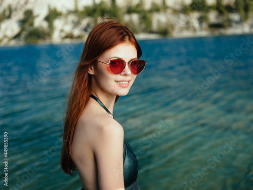 woman wearing sunglasses outdoors river posing rest green swimsuit