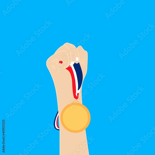 hand holding a medal with an upward direction when winning the fight