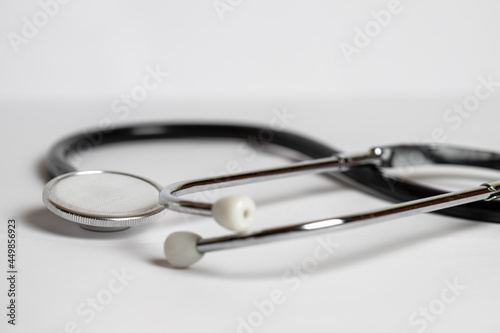 Medical black stethoscope on a white background
