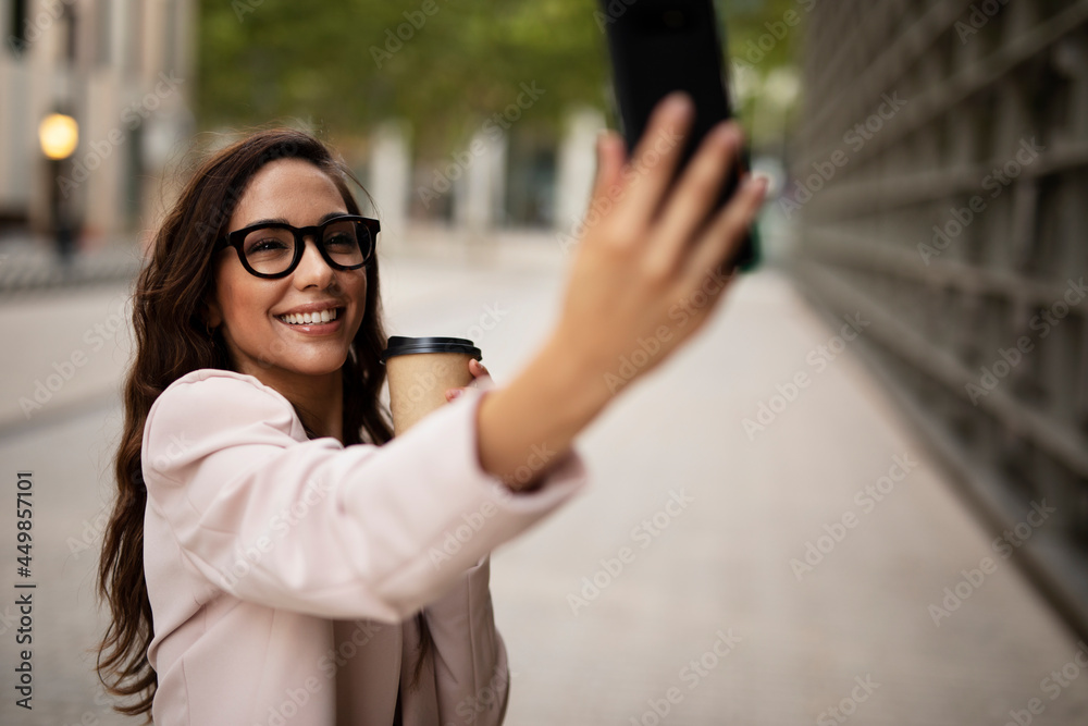 Young businesswoman using the phone. Female manager taking selfie photo