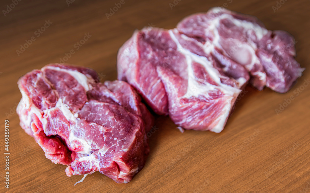 Obraz premium Chopped raw meat for steak on the kitchen board top view.