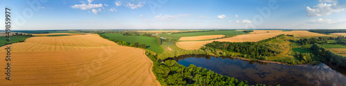 Aerial panoramic view of agricultural fields on a valley slopes