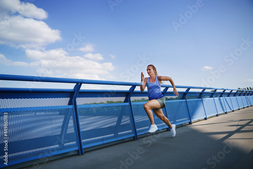 Mid adult woman running outdoors in city, healthy lifestyle concept.