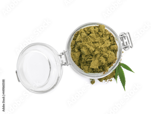 Jar with hemp protein powder and green leaf on white background, top view
