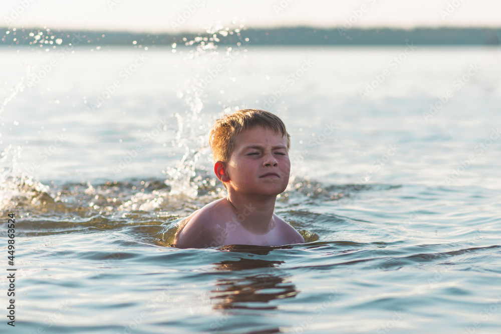 Happy smiling boy having fun swimming in the water.Cute boy swimming in water. Summer vacation. Happy smiling boy having fun swimming in the water.Cute boy swimming in water. Summer vacation.
