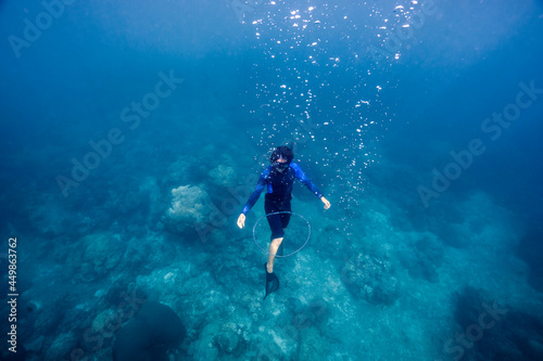 Freediver ascending with bubble ring