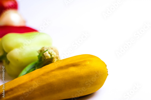 Ripe imperfect squash on blur vegetable background. Autumn still life with variety of colorful vegetables on white background. Happy Thanksgiving. Selective focus. photo