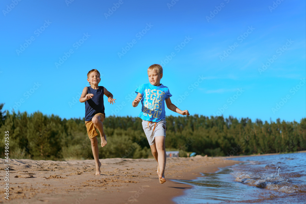 kids running alone beach. sunset and blue sky. Happy childhood concept kids running alone beach. sunset and blue sky. Happy childhood concept