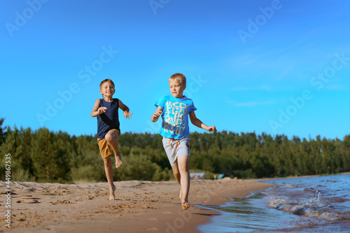 kids running alone beach. sunset and blue sky. Happy childhood concept