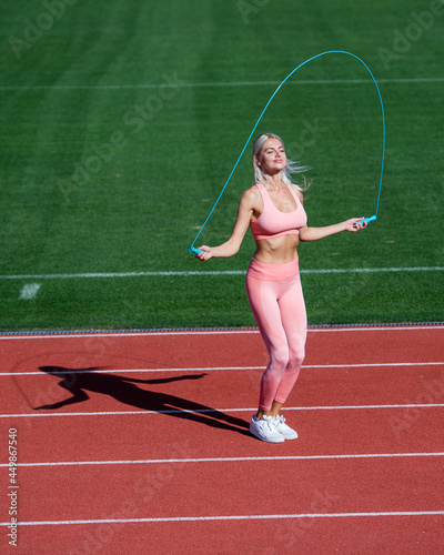 energetic woman athlete jumping on skipping rope warm up do sport workout, healthy lifestyle.