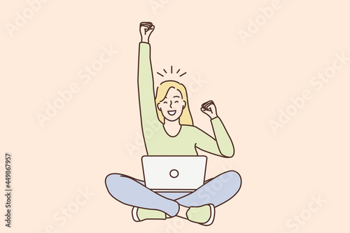 Celebrating success in work, freelance concept. Young smiling woman freelancer cartoon character sitting with laptop on knees with hand up gesturing like winner vector illustration 