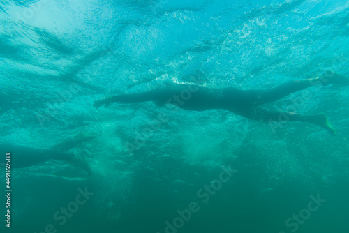 Triathlete swimming in a lake, underwater perspective