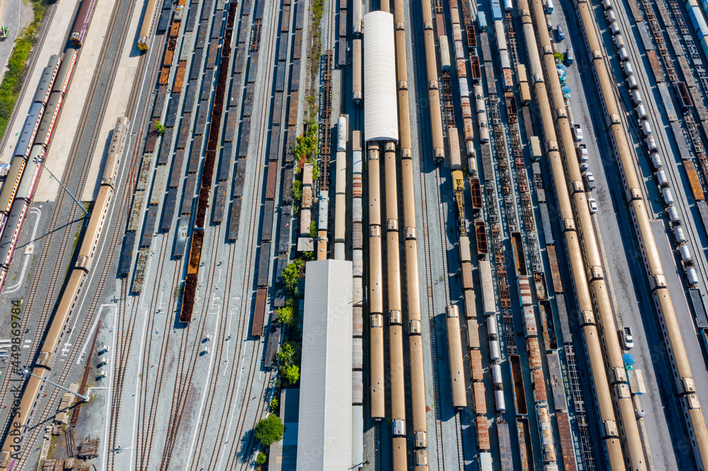 Aerial top view Passenger and freight trains on the railway station for transportation background. wagons with goods on railroad. Aerial top view Passenger and freight trains on the railway station for transportation background. wagons with goods on railroad.