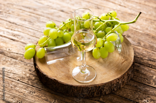 Italian golden grappa drink on rustic wooden table