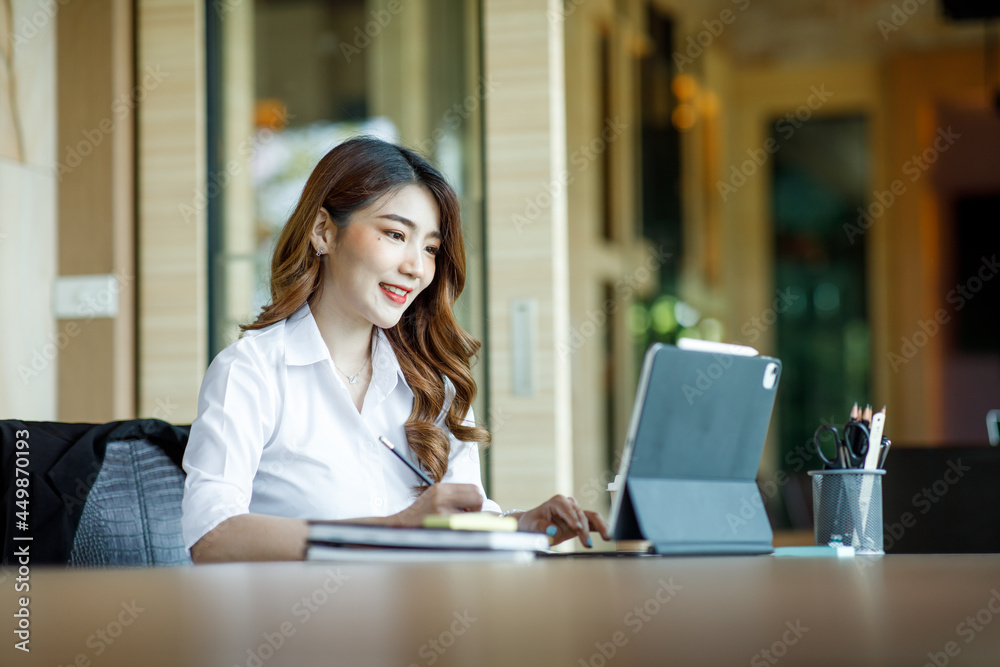 Asian Young Female using laptop computer at office. Student girl working at home. Work or study from home, freelance, business, lifestyle concept. Asian Young Female using laptop computer at office. Student girl working at home. Work or study from home, freelance, business, lifestyle concept.