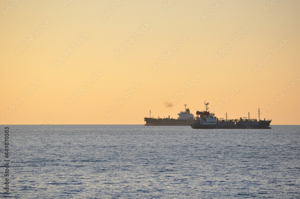 Shipping ships on the sea at sunset