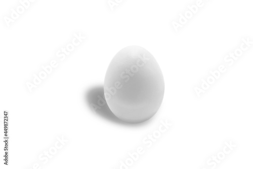 Isolated white chicken egg close-up on a white background. Free space. Minimalism. Tone to tone.