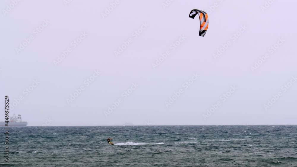 Kitesurfing During a Windy Day with a Very Rough Sea Kitesurfing During a Windy Day with a Very Rough Sea