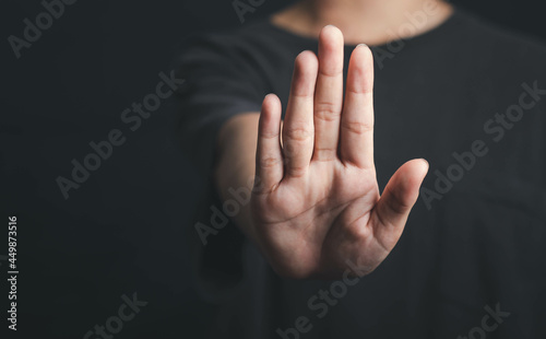 Human hand show stop sign, Hold arm one person stop gesture in dark tone. photo