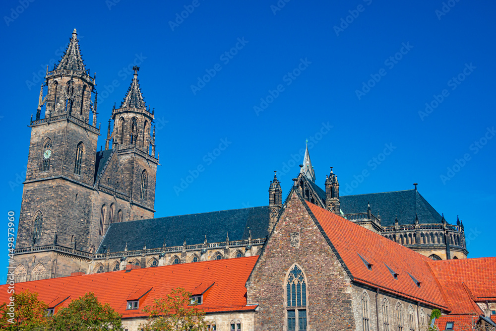 Magnificent old Cathedral in Magdeburg at golden Autumn colors, Germany, at blue sky and sunny day. Concept historical and religious heritage.