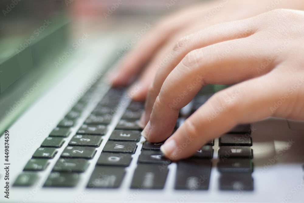 Woman's hand typing tablet keyboard at home, close up Woman's hand typing tablet keyboard at home, close up