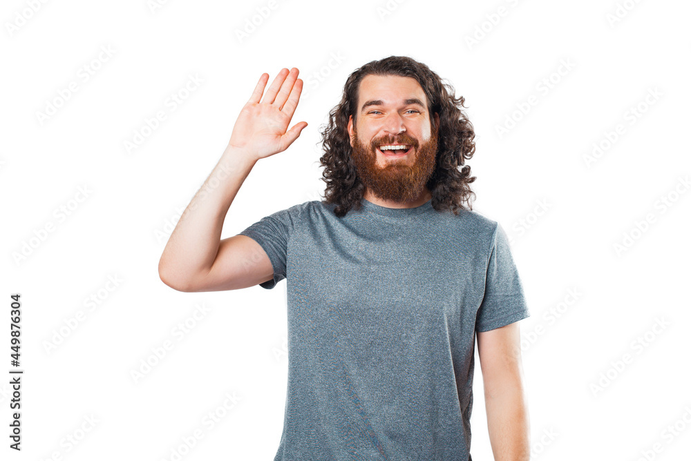 Cheerful young hipster man with beard saying hello, welcome gesture Cheerful young hipster man with beard saying hello, welcome gesture