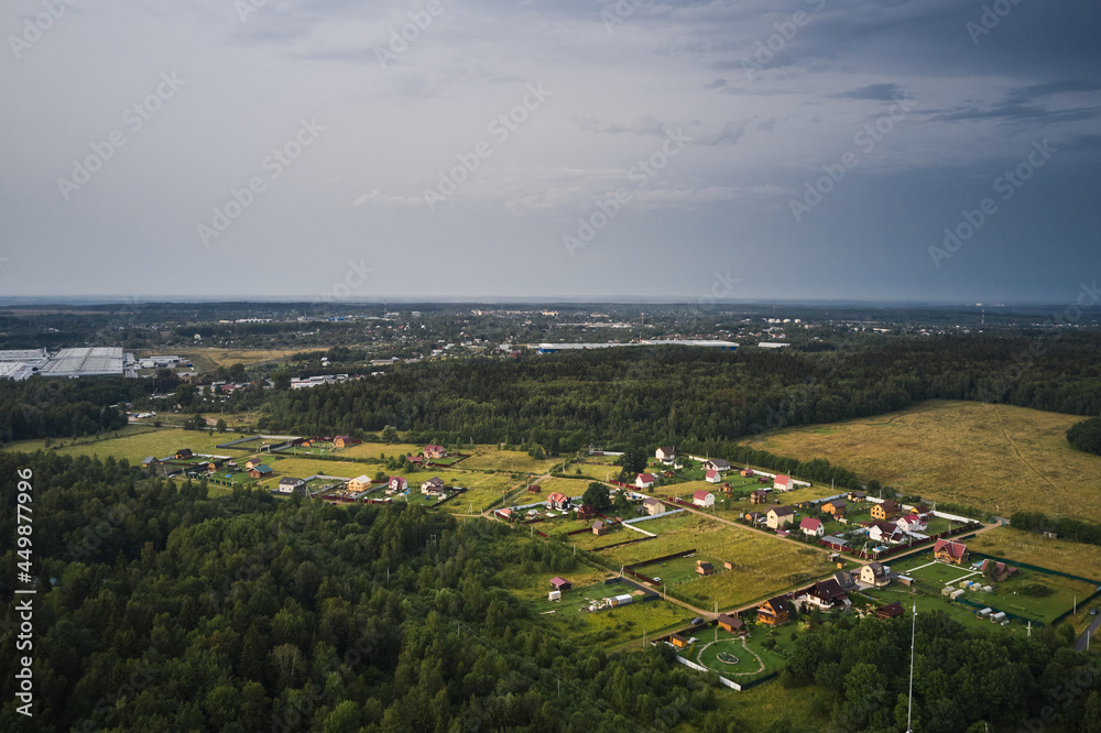 Fototapeta premium Small village with country road at summer, view from above