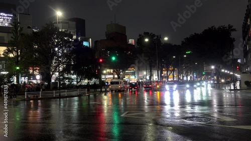 Road traffic near the Tokyo Harajuku station by rainy night.  Shibuya, Tokyo, Japan photo