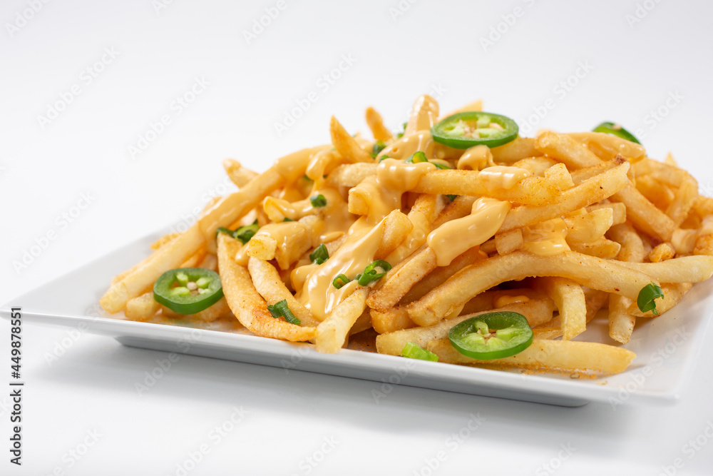 A view of a plate of nacho jalapeño cheese french fries. A view of a plate of nacho jalapeño cheese french fries.