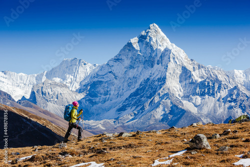 Woman Traveler hiking in Himalaya mountains with mount Everest, Earth's highest mountain. Travel sport lifestyle concept photo