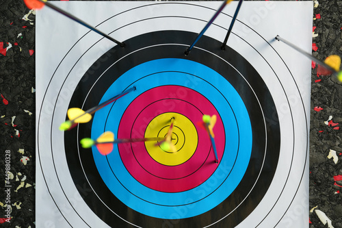 Many arrows in archery target, closeup view photo