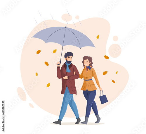 People in fall, enjoying autumn activity. Couple walking together with an umbrella in rain and falling autumn leaves. Happy loving married couple walking on rainy day and talking