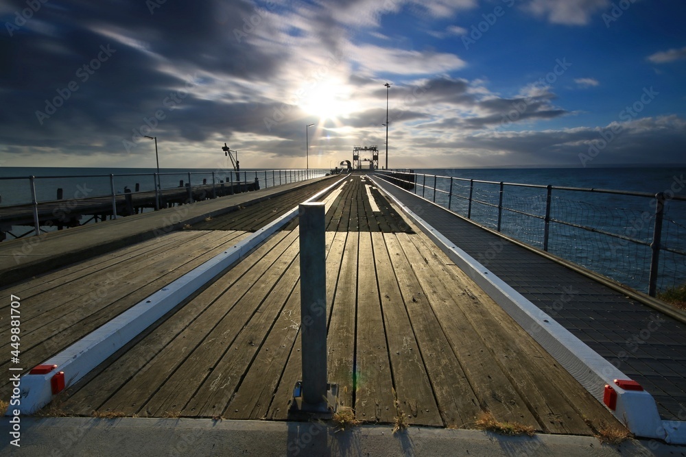 a wooden pier next to a body of water and kingscote