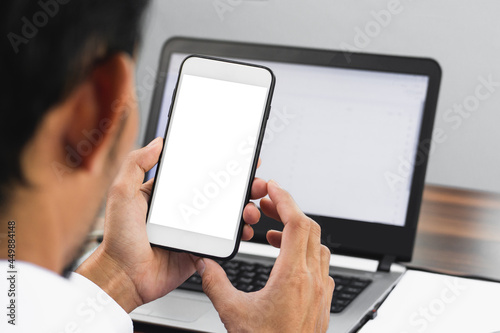 Closeup businessman using smartphone working in office