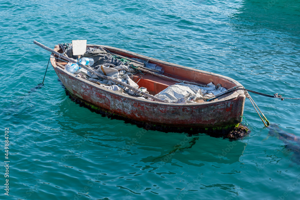 Abandoned wooden boat on the sea during sunny summer day