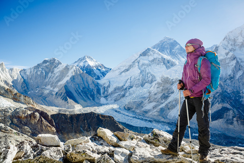 Woman Travelerh hiking in Himalaya mountains. Face to face with mount Everest, Earth's highest mountain. Travel sport lifestyle concept