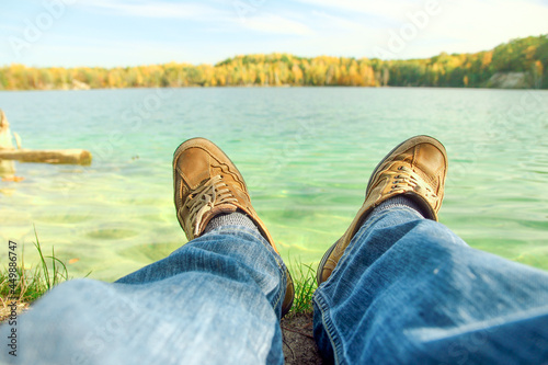 man in shoes near the lake