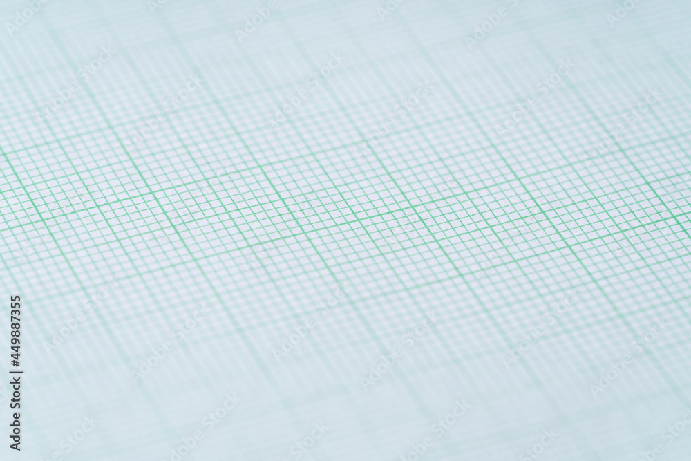 close up of green graph paper, research and education concept close up of green graph paper, research and education concept