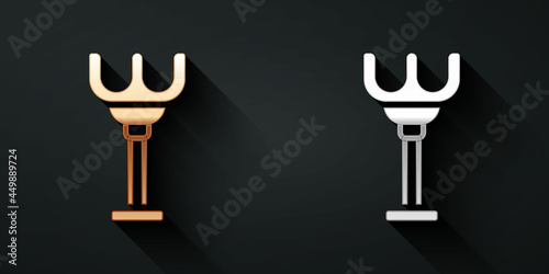 Gold and silver Rake toy icon isolated on black background. Children toy for beach games. Long shadow style. Vector