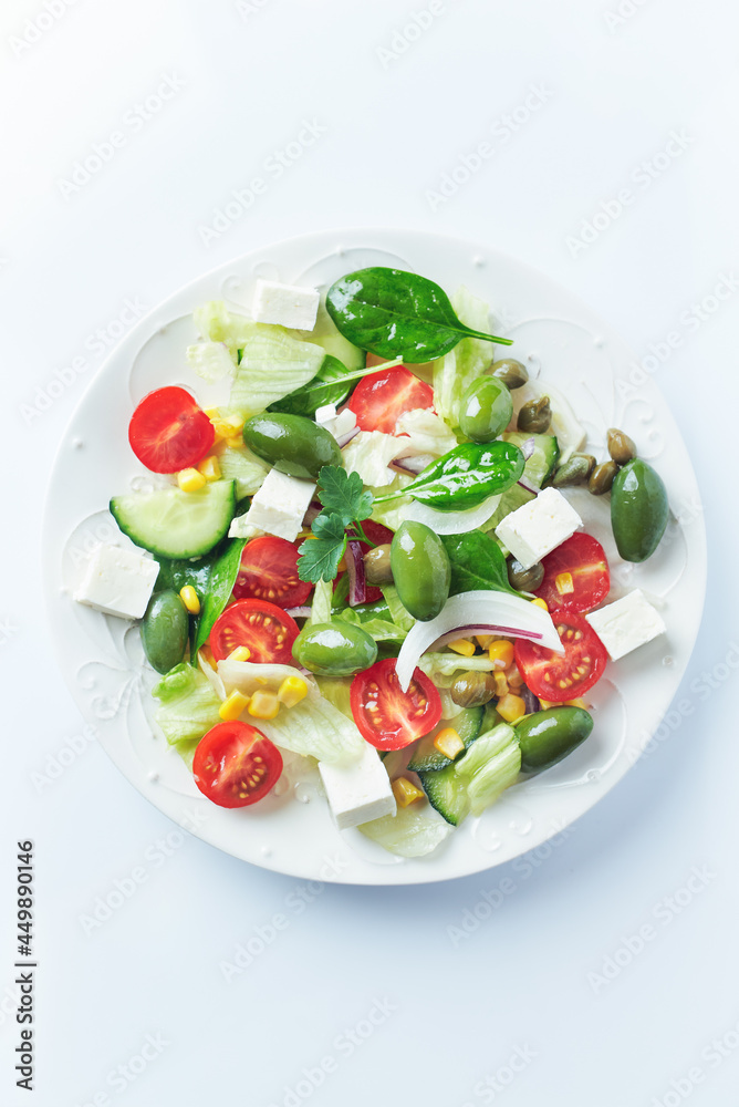 Healthy Salad with Feta Cheese, Green Olives, Baby Spinach, Cucumber, Cherry Tomatoes and Capers. Bright background. Top view. Healthy Salad with Feta Cheese, Green Olives, Baby Spinach, Cucumber, Cherry Tomatoes and Capers. Bright background. Top view.