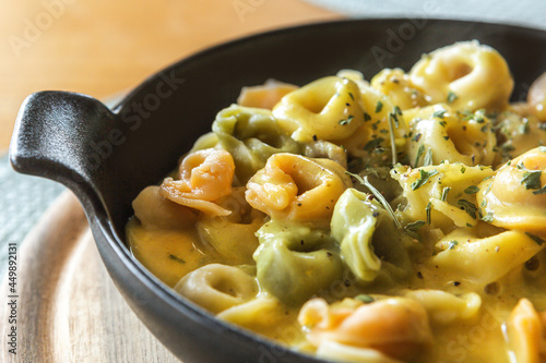 Close-up of tortellini in curry sauce  photo