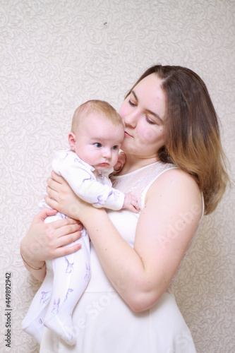 home photos of a young mother with a small child. Newborn boy. Cute, cozy photos with a baby.