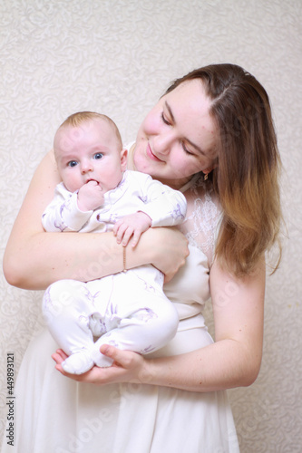 home photos of a young mother with a small child. Newborn boy. Cute, cozy photos with a baby.