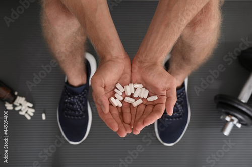 Man with handful of pills, top view. Doping concept