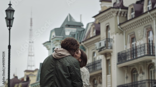 Love couple kissing on urban street. Happy man and woman enjoying date outdoor.