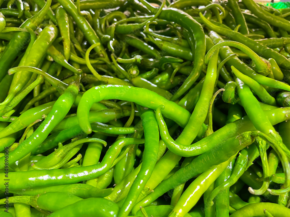 Freshly plucked raw green chillies kept at a supermarket stall Freshly plucked raw green chillies kept at a supermarket stall