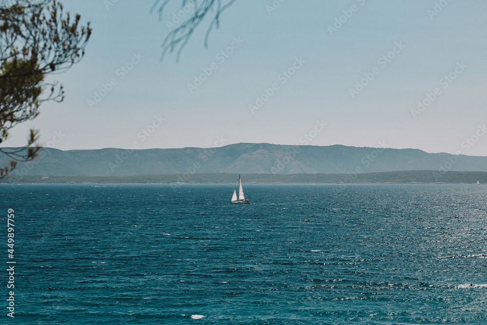 Sailboat in Bol Croatia during summer time bllue water