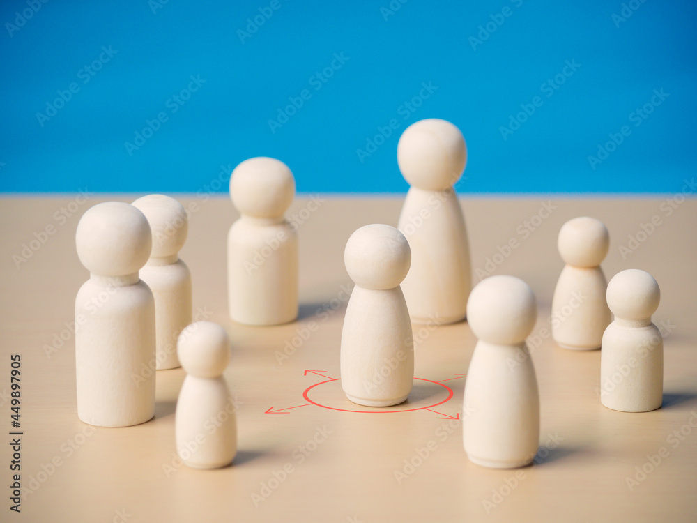 Wooden figure standing in red and arrow cycle showing social distancing concept prevention and protection from Coronavirus or COVID-19 outbreak spreading.Social and Physical distancing. Wooden figure standing in red and arrow cycle showing social distancing concept prevention and protection from Coronavirus or COVID-19 outbreak spreading.Social and Physical distancing.