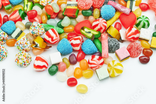 Multi-colored gummy candies on a white background. Festive backdrop.